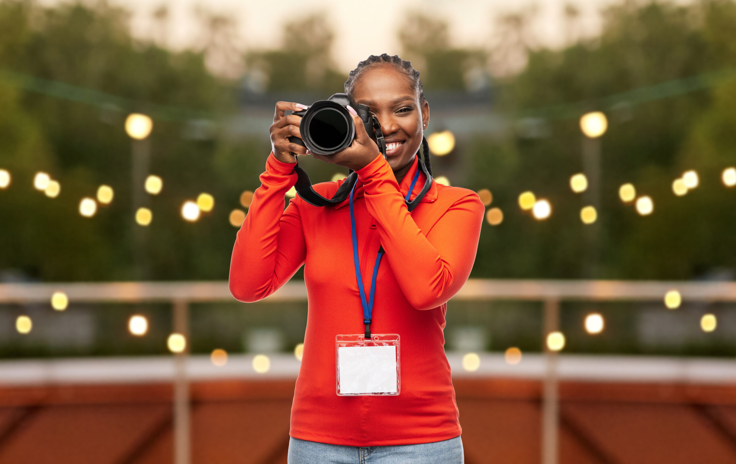african american woman with camera and medal on city terrace