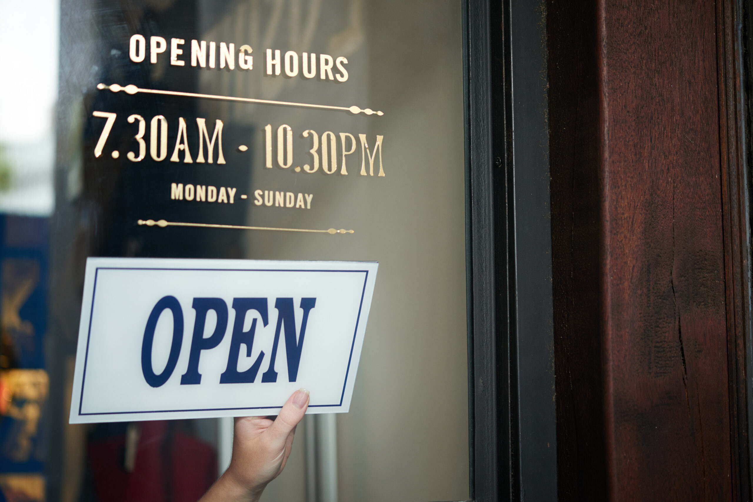 Open house sign in front of shop window for rent